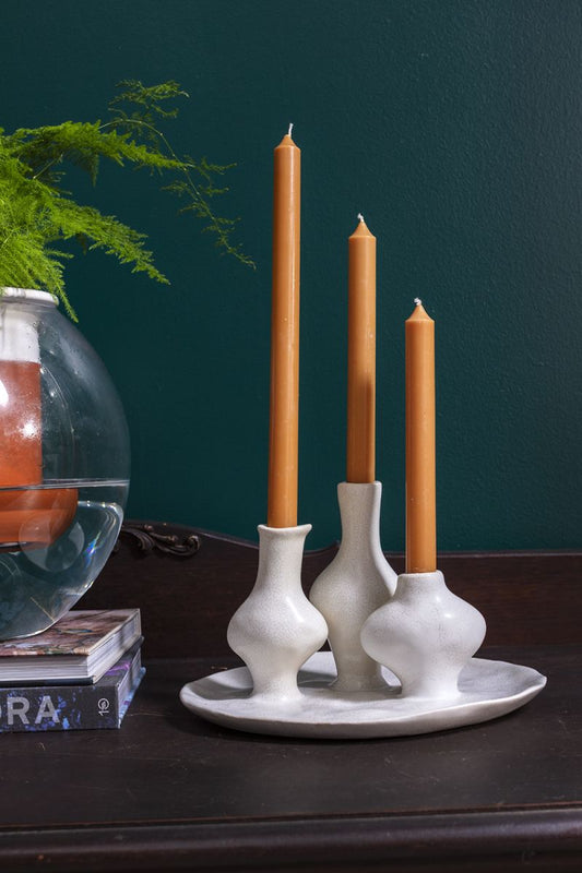 A budvase trio finished in glazed white ceramic on an attached white tray.