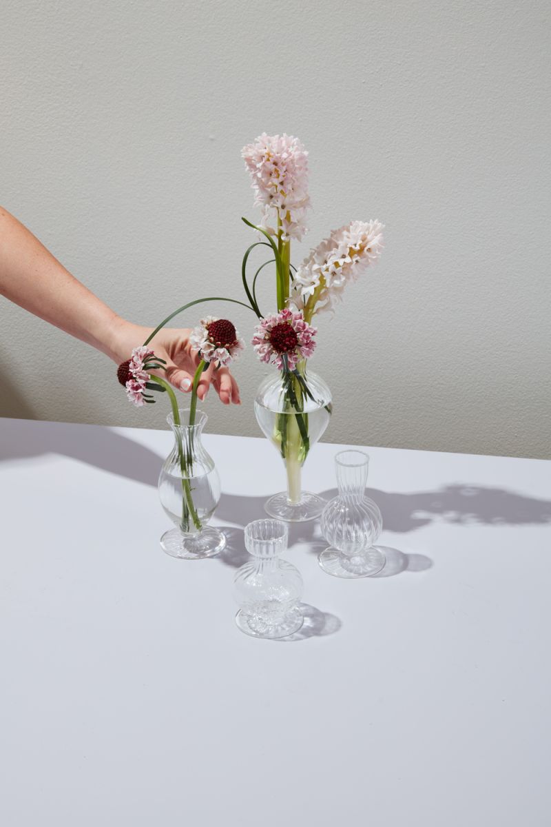 Ribbed glass budvases in two fluted shapes.