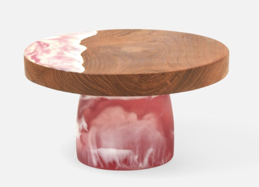 Teak and resin, two materials handcrafted together, bring a splash of color to any setting. These two-tone cake stands are hand-dipped, making each one-of-a kind pink and white beauty.