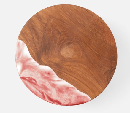 Teak and resin, two materials handcrafted together, bring a splash of color to any setting. These two-tone cake stands are hand-dipped, making each one-of-a kind pink and white beauty.