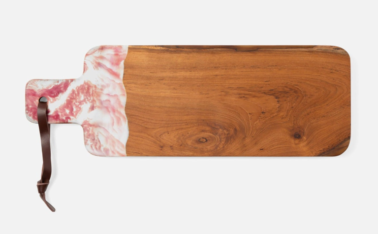 Teak and resin, two materials handcrafted together, bring a splash of color to any setting. Available in unique two-tone, hand-dipped colors, no two cutting boards are exactly alike.