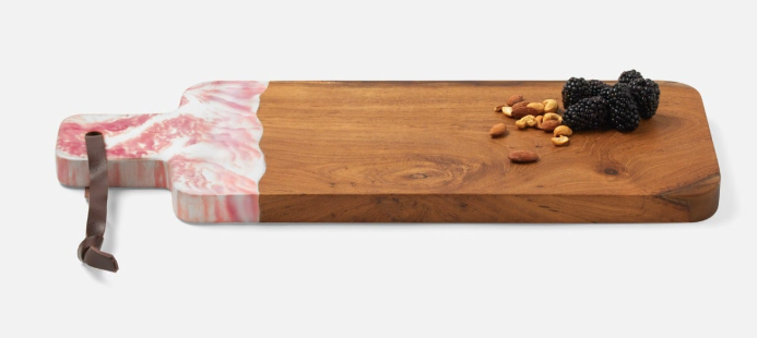 Teak and resin, two materials handcrafted together, bring a splash of color to any setting. Available in unique two-tone, hand-dipped colors, no two cutting boards are exactly alike.