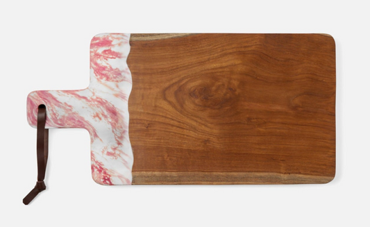 Teak and resin, two materials handcrafted together, bring a splash of color to any setting. Available in unique two-tone, hand-dipped colors, no two cutting boards are exactly alike.