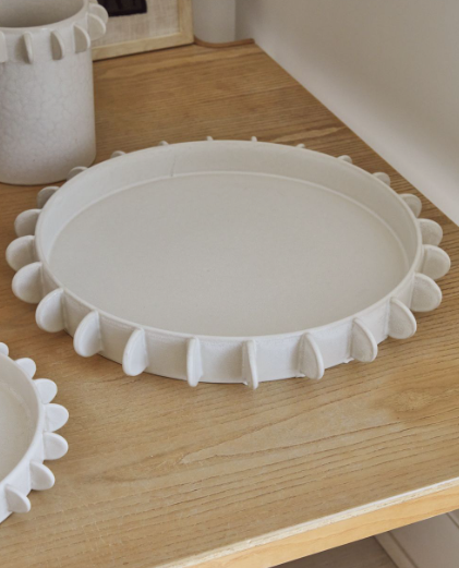 Ceramic tray with hand applied tabs to the rim. Comes in two sizes.