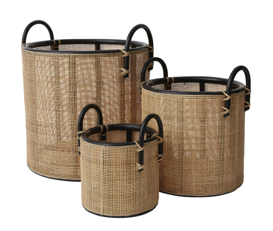 set of three woven natural baskets with black handles.