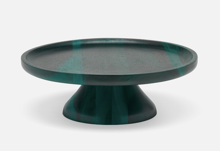 The Bryce cake stand is crafted from acacia wood and finished in a striking emerald finish.