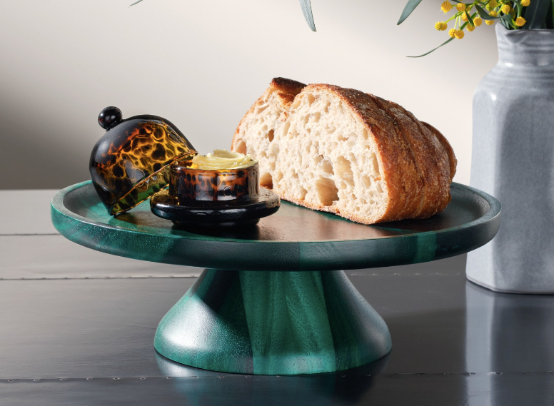 The Bryce cake stand is crafted from acacia wood and finished in a striking emerald finish