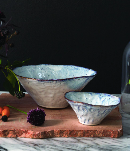 Vessel has a wavy rim and irregular sanded glaze with purple, iridescent and blue tones.