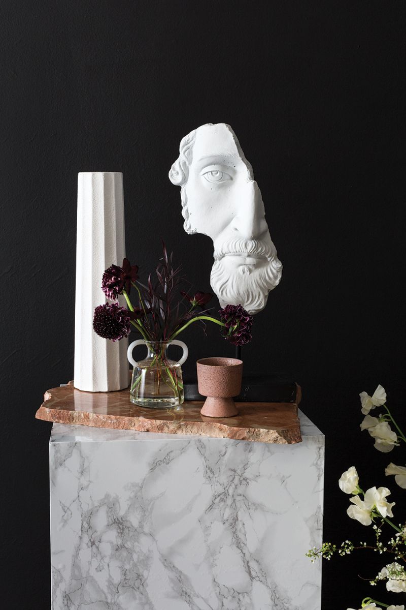 Inspired by ancient ruins, the Acropolis Stand is molded from cement and mounted on a black metal stand.