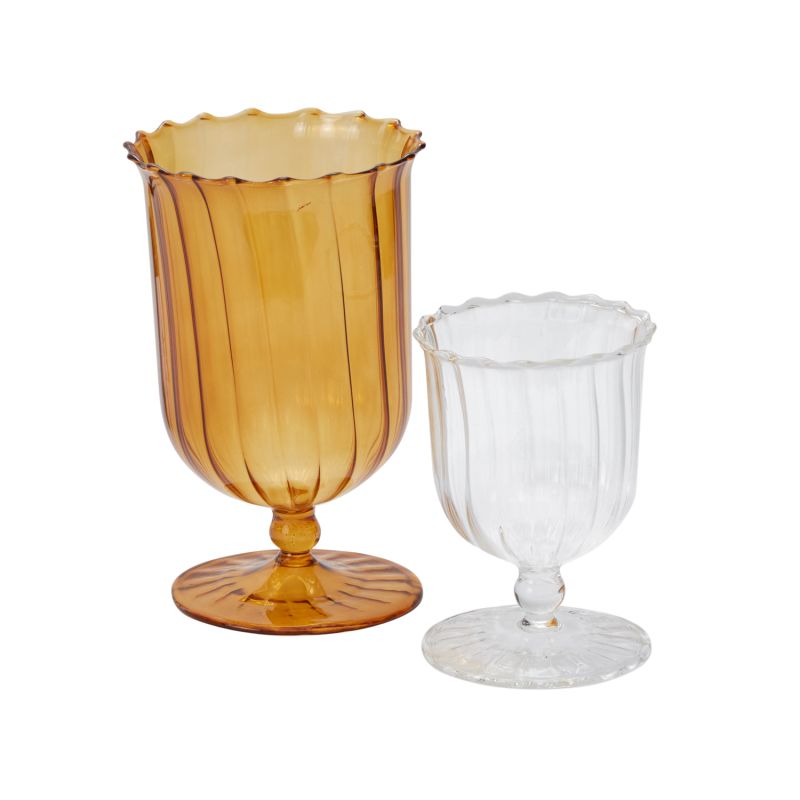 Create a beautiful home or classic table setting with the blown glass April Vase, beautifully traditional with a twist. Comes in clear or a warm amber shade.