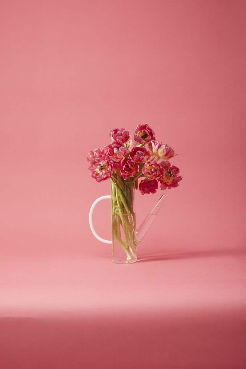 Delicate glass watering can with white glass handle and elegant spout makes a perfect decorative or useful piece for every floral design.