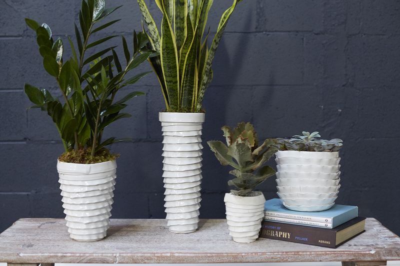 Glazed ceramic vases that features textured, uneven layers..