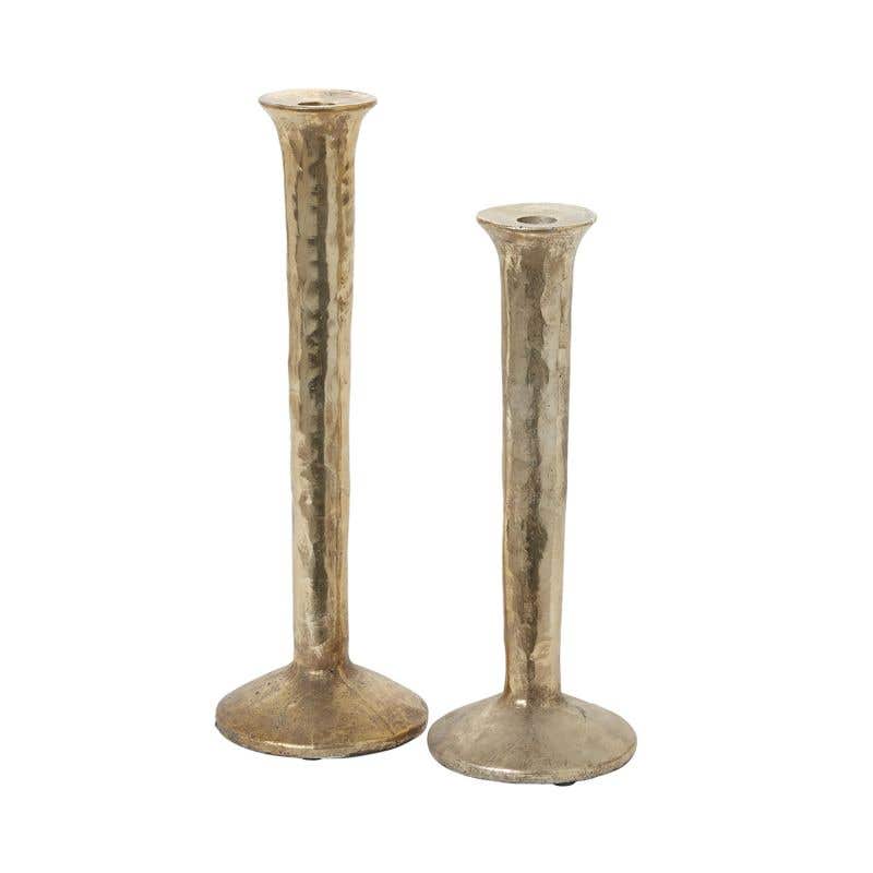 spool-shaped metal candle holder is made from polyresin with a mottled gold finish