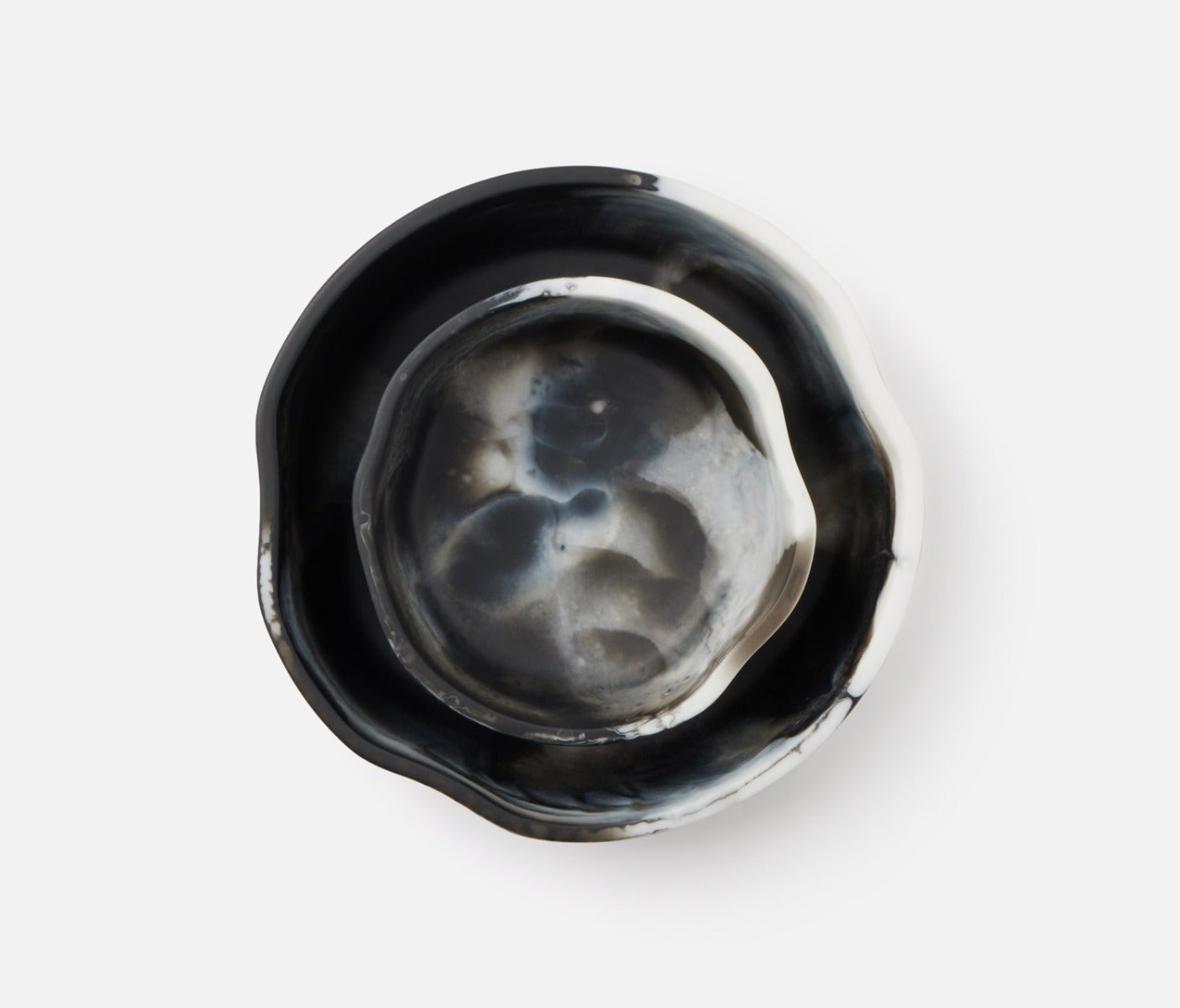 Swirling resin and irregular shapes give this generously proportioned serving bowl set a natural, laid-back vibe. Eye-catching and versatile, Beatrix brings unconventional beauty to the kitchen, dining room, or patio.