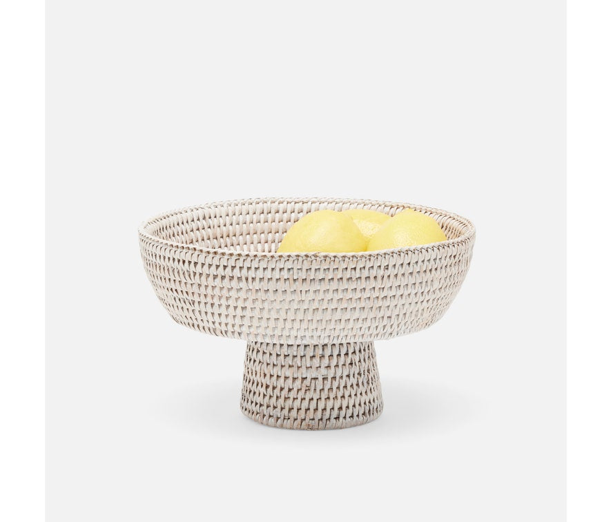 Footed, rattan pedestal bowl with lemons displayed.